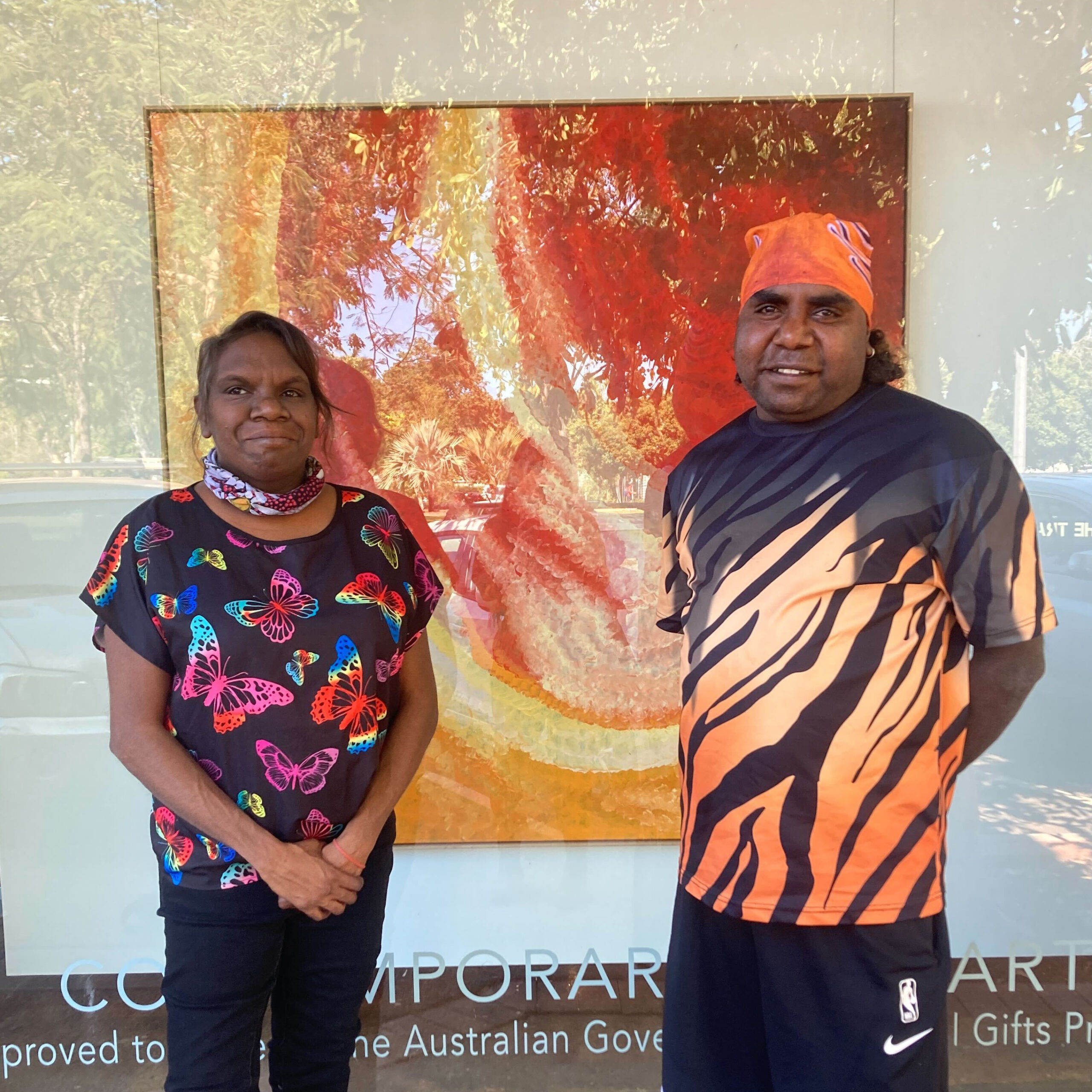 Martumili Artists Exhibitions at Paul Johnstone Gallery in Darwin: Indigenous Martu Artists Corban Clause Williams and Sylvia Wilson visiting Bugai Whyoulter's exhibition at Paul Johnstone Gallery.